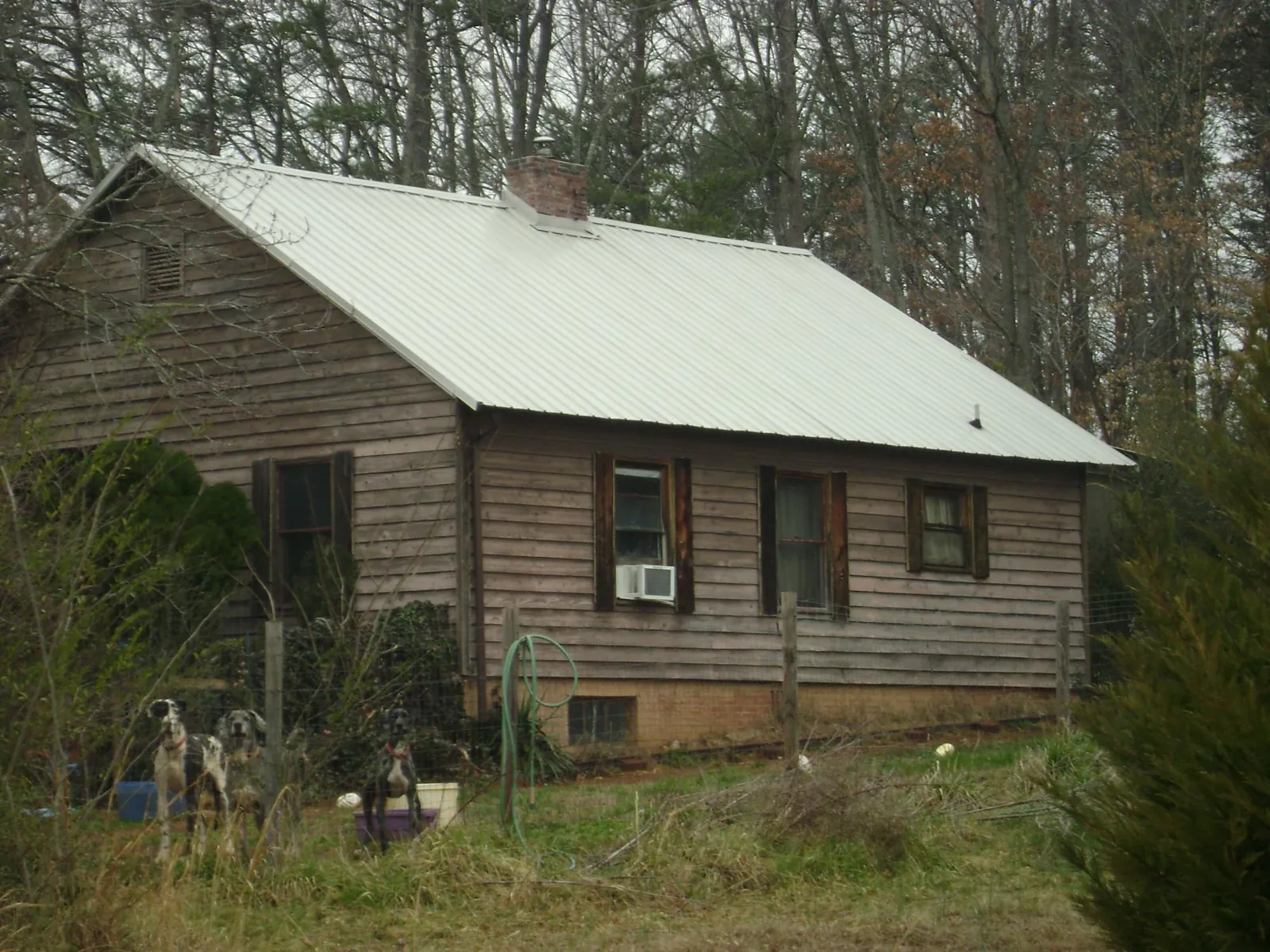 White metal roof on an old wood sided farmhouse, from a Asphalt Shingle Roof Repair job in Capitol Heights